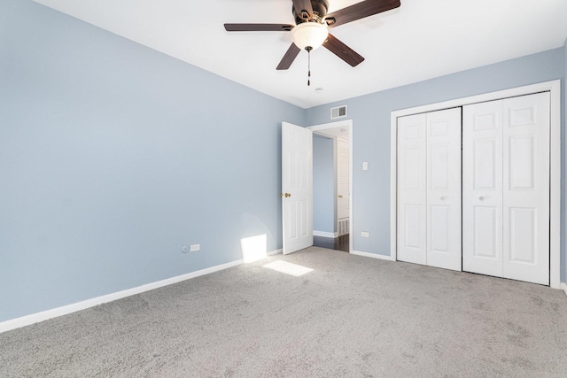 unfurnished bedroom featuring visible vents, carpet flooring, baseboards, and a closet