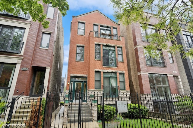 1825 W Iowa St Unit 2, Chicago, IL 60622 - townhome / multi-family property featuring a gate, a fenced front yard, and brick siding