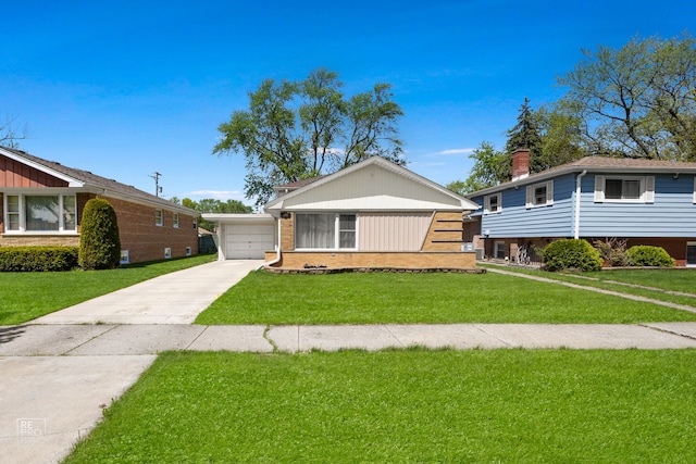 4704 W 99th St, Oak Lawn, IL 60453 - split level home featuring a front lawn, a garage, brick siding, and driveway