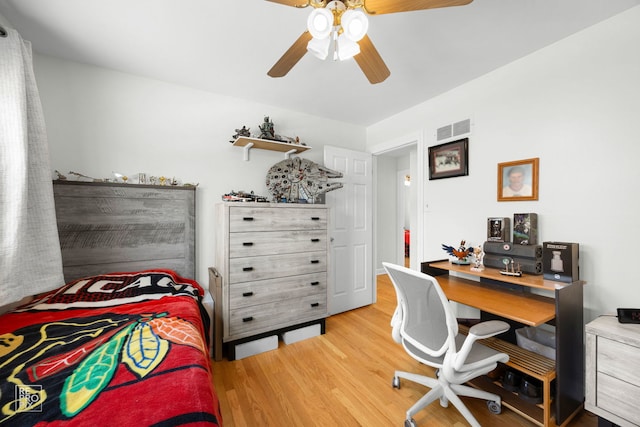 4704 W 99th St, Oak Lawn, IL 60453 - bedroom with wood finished floors, a ceiling fan, and a desk