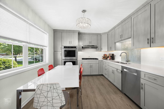 4704 W 99th St, Oak Lawn, IL 60453 - kitchen featuring stainless steel appliances, gray cabinets, under cabinet range hood, and wood finished floors