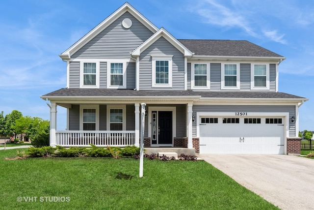 view of front facade with a front yard, concrete driveway, covered porch, a garage, and a shingled roof