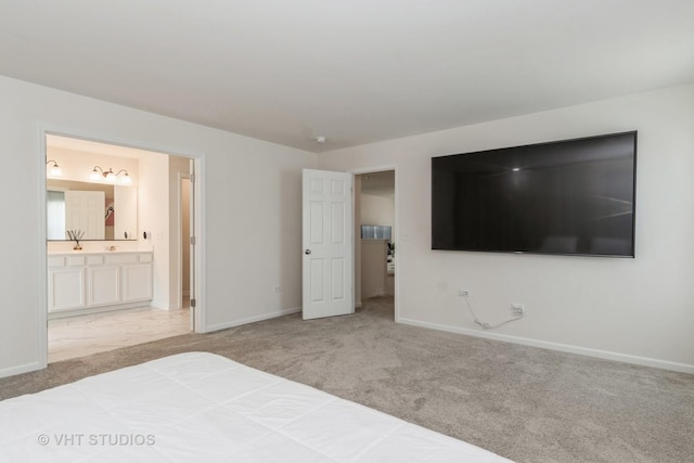 unfurnished bedroom with carpet, baseboards, and ensuite bathroom