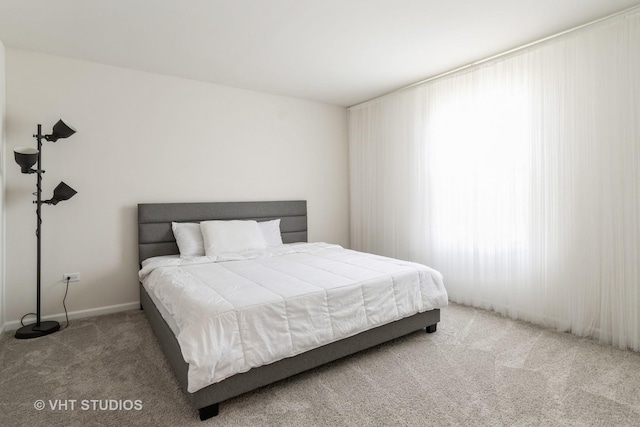 bedroom with carpet floors and baseboards
