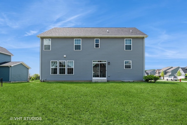 back of house featuring a yard