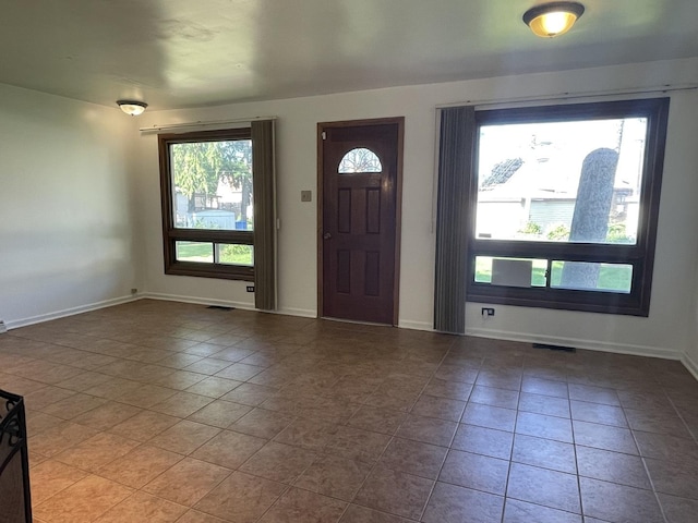 entrance foyer featuring tile patterned floors and baseboards