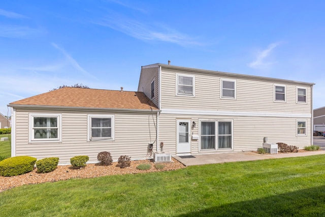 rear view of property featuring a yard, central AC, and a patio