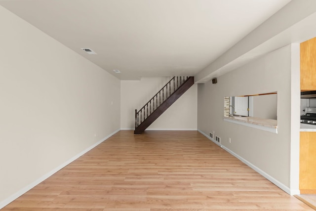 empty room with light wood-style floors and baseboards