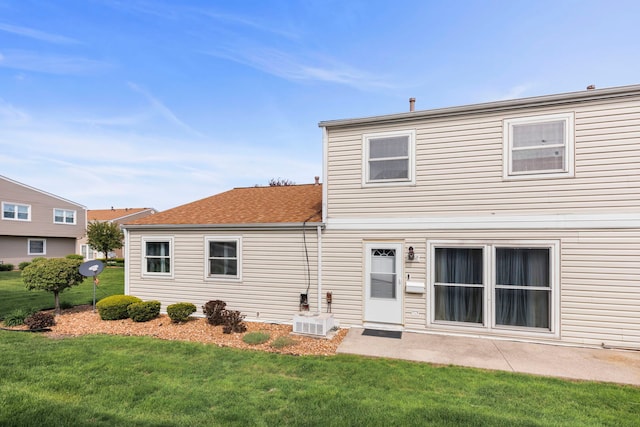 rear view of property with a lawn