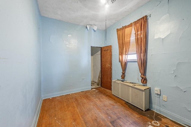6835 S Winchester Ave, Chicago, IL 60636 - unfurnished room featuring baseboards, radiator, and hardwood / wood-style floors