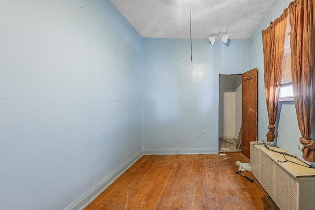 6835 S Winchester Ave, Chicago, IL 60636 - empty room with baseboards, radiator heating unit, and hardwood / wood-style floors