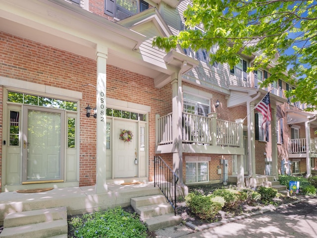 doorway to property with brick siding
