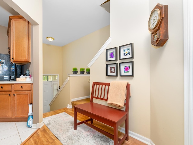 interior space featuring baseboards and light wood finished floors