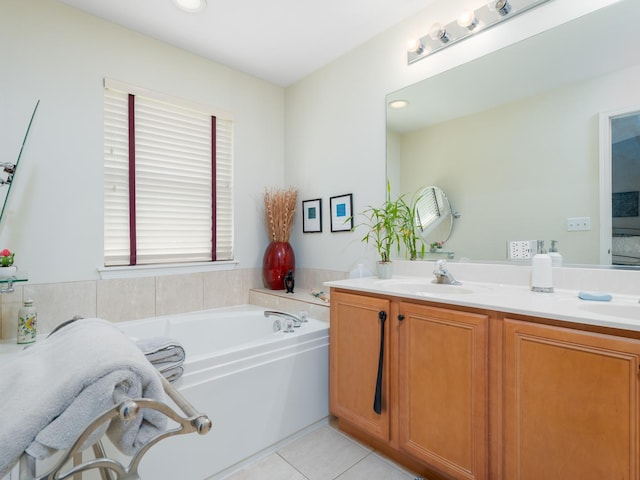 bathroom with double vanity, tile patterned floors, a bath, and a sink