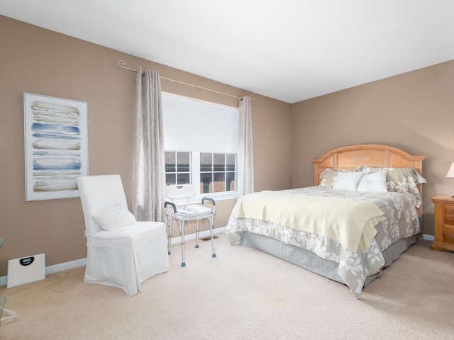 bedroom featuring baseboards and carpet