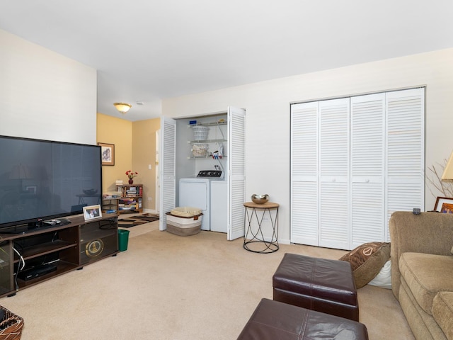 carpeted living area featuring washer and dryer
