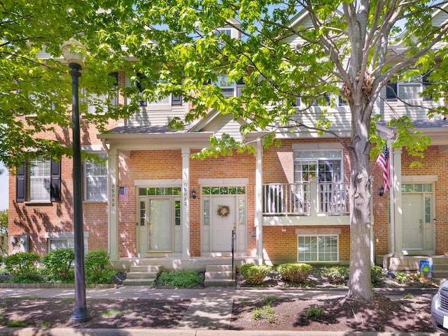 townhome / multi-family property with brick siding