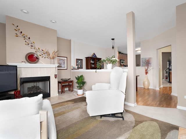 carpeted living room featuring baseboards, recessed lighting, wood finished floors, and a fireplace