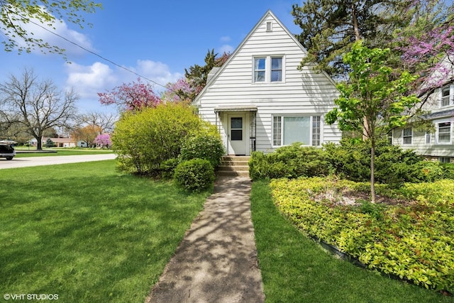 bungalow-style home featuring a front lawn