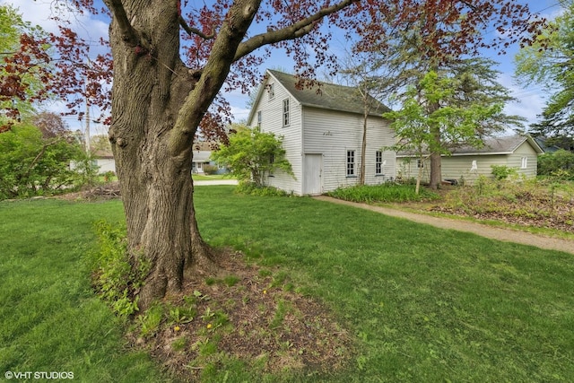 view of property exterior with a lawn