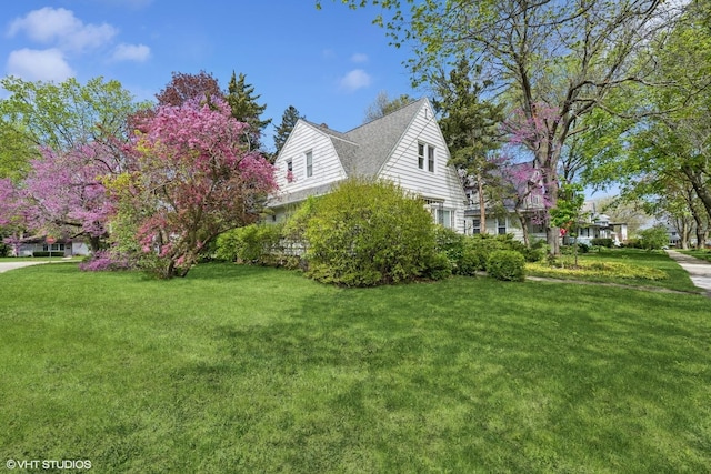 view of side of property with a yard