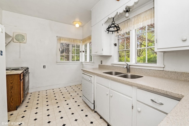kitchen with light countertops, black range, a sink, white cabinets, and dishwasher