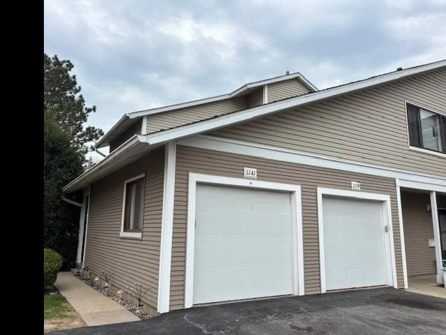 1141 E Randville Dr, Palatine, IL 60074 - view of property exterior featuring an attached garage and aphalt driveway