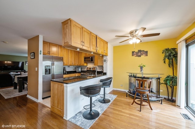 1141 E Randville Dr, Palatine, IL 60074 - kitchen featuring light wood-style flooring, a breakfast bar, stainless steel appliances, visible vents, and ceiling fan