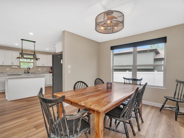 dining room with recessed lighting, baseboards, and light wood-style floors