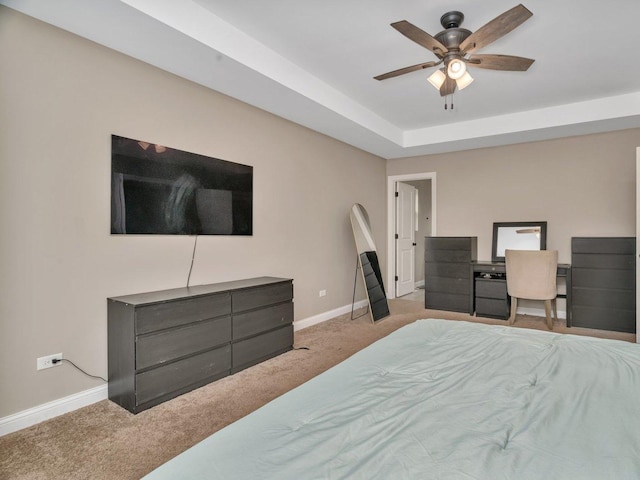 carpeted bedroom with ceiling fan and baseboards