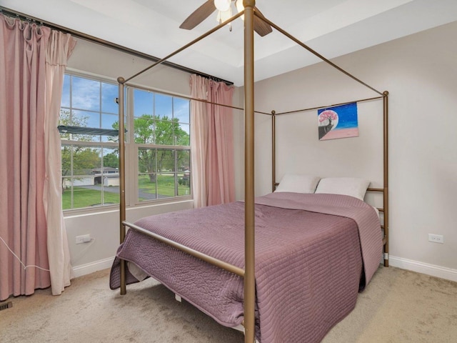 carpeted bedroom featuring ceiling fan and baseboards