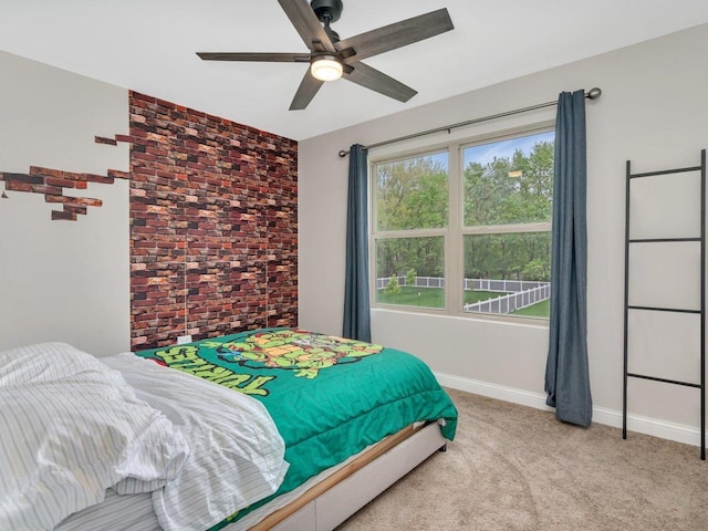 bedroom with ceiling fan, light carpet, and baseboards