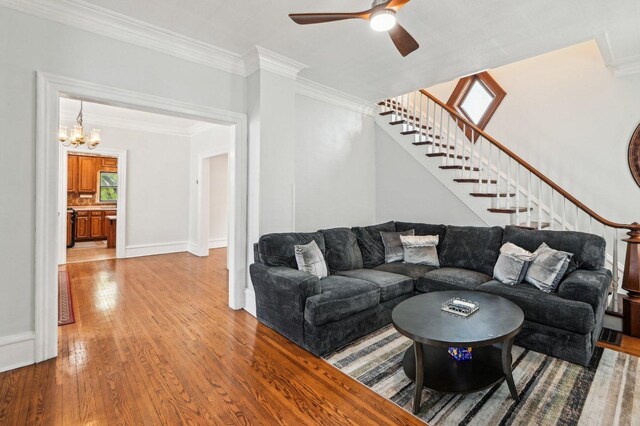 108 N Channing St, Elgin, IL 60120 - living room featuring stairs, crown molding, light wood finished floors, a ceiling fan, and a chandelier