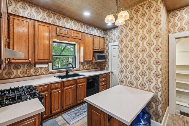 108 N Channing St, Elgin, IL 60120 - kitchen with a sink, wallpapered walls, light countertops, light wood finished floors, and black appliances