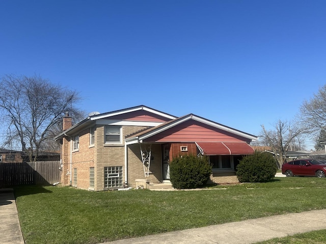644 E 154th St, Dolton, IL 60419 - tri-level home with fence, a chimney, brick siding, and a front yard