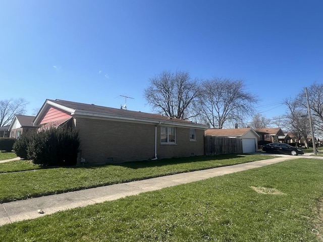 644 E 154th St, Dolton, IL 60419 - view of side of property featuring concrete driveway, fence, a yard, and a detached garage
