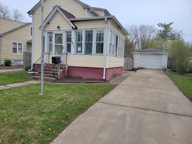2811 Ezekiel Ave, Zion, IL 60099 - bungalow-style house with a front yard, an outbuilding, a garage, fence, and concrete driveway
