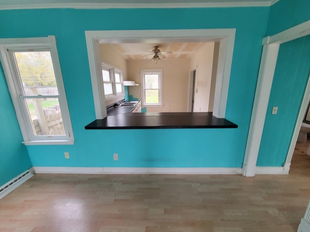 2811 Ezekiel Ave, Zion, IL 60099 - unfurnished dining area with a sink, baseboards, a baseboard heating unit, and wood finished floors
