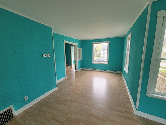 2811 Ezekiel Ave, Zion, IL 60099 - empty room featuring crown molding, baseboard heating, baseboards, wood finished floors, and visible vents