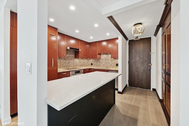kitchen featuring under cabinet range hood, recessed lighting, light wood-style flooring, and oven