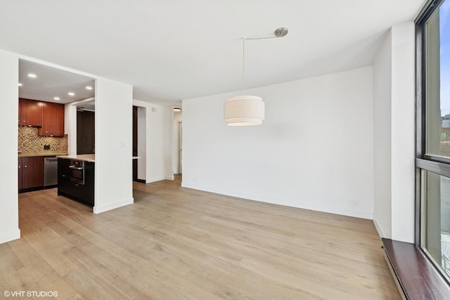 unfurnished living room featuring baseboards, recessed lighting, and light wood-style flooring