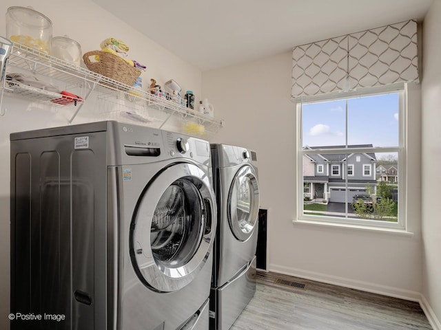 257 Kennedy Dr, Saint Charles, IL 60175 - washroom with separate washer and dryer, wood finished floors, and baseboards