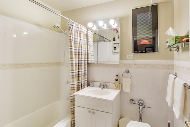 6030 N Sheridan Rd Unit 411, Chicago, IL 60660 - bathroom with tile walls, toilet, a wainscoted wall, vanity, and shower / tub combo with curtain