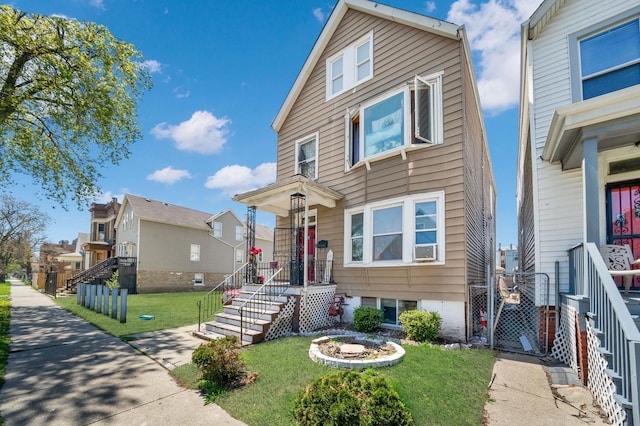 view of front of home with a front lawn, fence, a residential view, and cooling unit