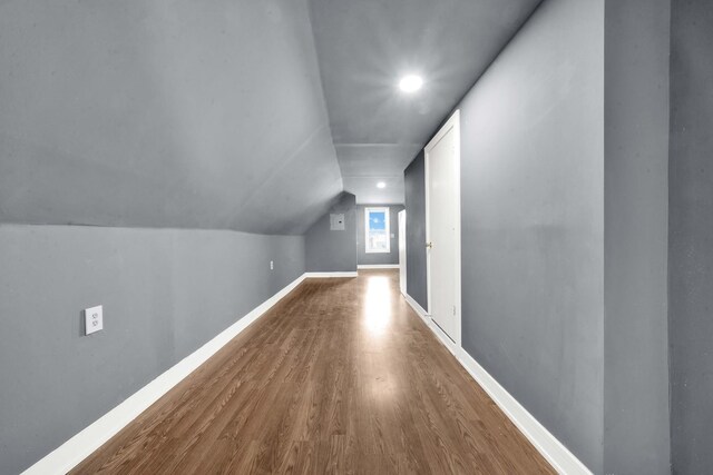 additional living space with recessed lighting, baseboards, vaulted ceiling, and wood finished floors