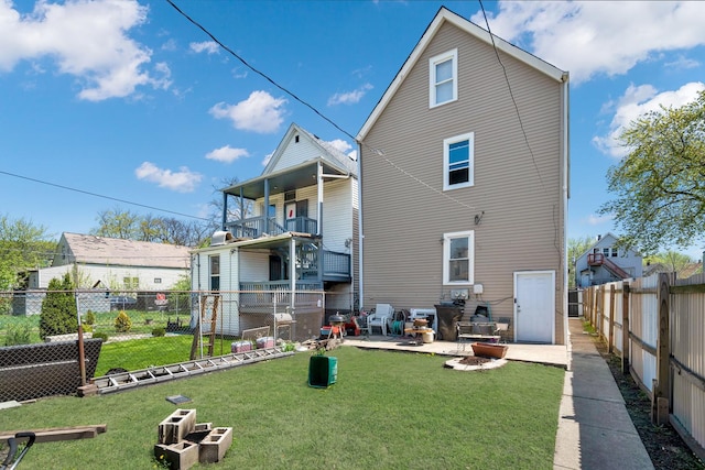 back of house featuring a patio, a fenced backyard, and a yard