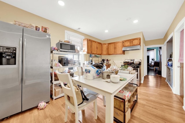 kitchen featuring recessed lighting, appliances with stainless steel finishes, under cabinet range hood, and light wood-type flooring