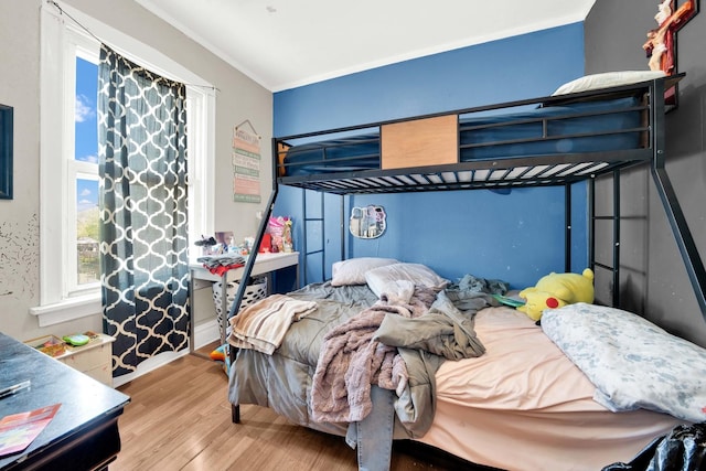 bedroom with baseboards and wood finished floors