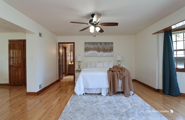bedroom featuring light wood-type flooring, baseboards, and a ceiling fan