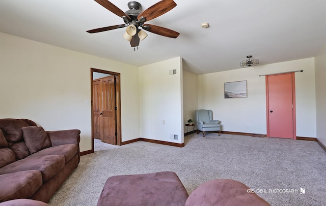 living area featuring carpet flooring, a ceiling fan, and baseboards